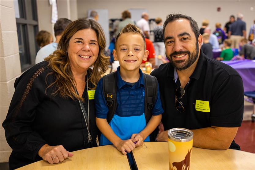 A family smiles at Winstead Elementary's Grandparents Breakfast